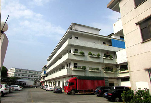 Truck loading finished plush toy cartons outside the BuyChinaToys factory building